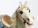 a toy horse that is sitting next to a bowl
