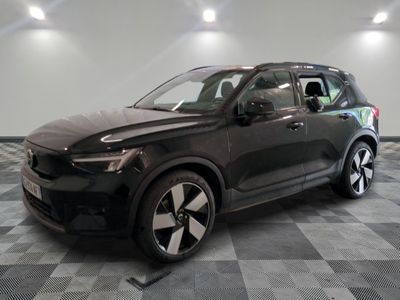 le 4x4 noir est garé sur un sol en damier dans le garage