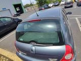 a silver car parked in a parking lot next to a building