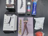 various items that are on a table including a bottle of wine, a pair of socks, a book, and a pair of scissors