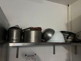 pots and pans on a shelf in a kitchen