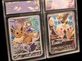 three pokemon trading cards are displayed in a display case