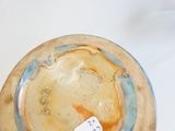 a brown and blue bowl with a tag on it