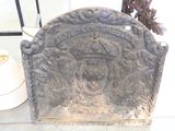 a stone plaque with a crown on top of it