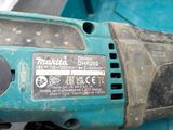 a person holding an electric drill in their hand
