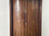 a large wooden cabinet with a door on top of it