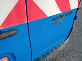 a close up of a blue and red truck with a red and white stripe on the side