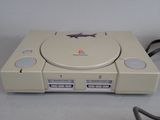 a video game console sitting on a table next to a charger