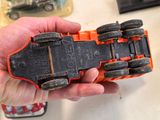 a person holding a toy car in their hand