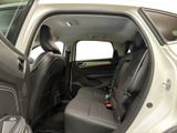 the back seats of a car with a suitcase in the back