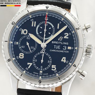 a close up of a wrist watch with a blue dial