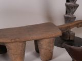 a wooden bench with a knife on top of it