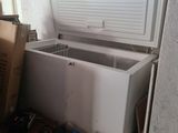 a white chest freezer sitting on top of a wooden table