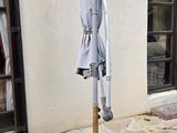 a umbrella that is on a pole outside of a building