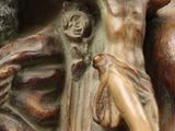 a statue of jesus on the cross with a woman on it