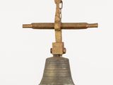 a bell with a cross on top of it on a white background