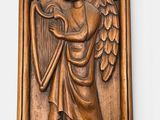 a wooden plaque of an angel holding a harp