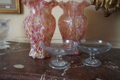 trois vases en verre posés sur une table à côté d'un miroir