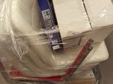 a stack of boxes and a chair in a warehouse