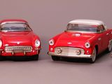 several toy cars are lined up in a row on a gray surface