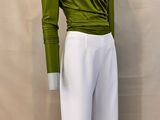a close up of a mannequin wearing a green top and white pants