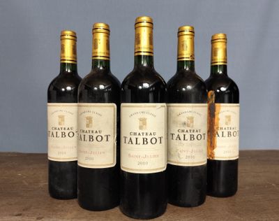 four bottles of red wine are lined up on a table