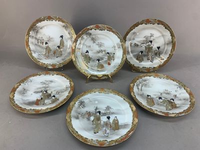 six porcelain plates with animals painted on them sitting on a table
