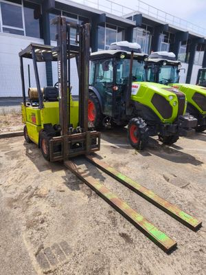 three yellow and green tractors parked next to each other in front of a building