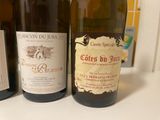 three bottles of wine sitting on a counter next to each other