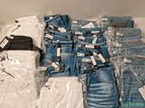 a pile of jeans and other clothing on a table