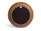 brown leather round ottoman with a black cushion on a white background