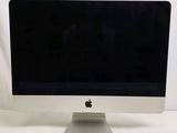 a computer monitor sitting on top of a white table