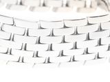 a close up of a white bracelet on a white surface