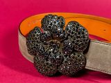 the belt is decorated with black and white flowers