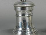 pair of silver salt and pepper shakers on a gray surface