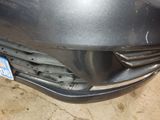 the front bumper of a car with a number plate on it