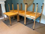 four wooden chairs that are sitting on top of each other