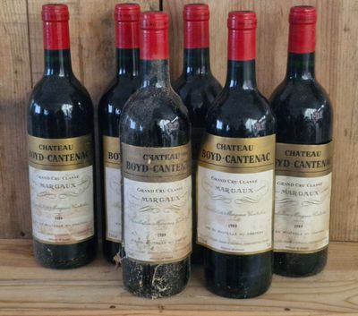 six bottles of wine are lined up on a wooden shelf