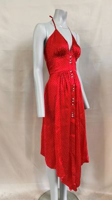 red and white polka dress on a mannequin base