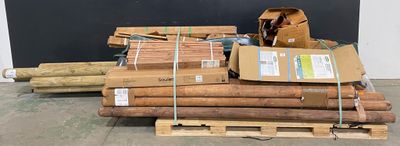 a pile of wood sitting on a pallet in front of a blackboard
