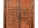 an old wooden cabinet with two doors and two drawers