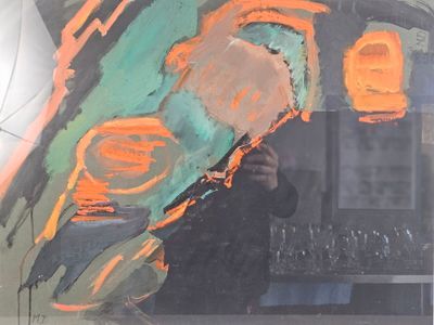 a man taking a picture of a painting in a mirror