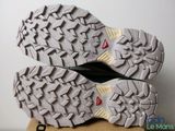 the soles of a pair of shoes on top of a cardboard box