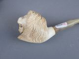 a pipe with a lion head on it sitting on a table