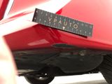 a sticker on the back of a red car