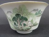 a small bowl with a painting on it on a table