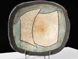 a plate that is sitting on a stand on a table