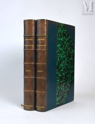 two books are stacked on top of each other on a white surface