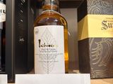 a bottle of liquor on a shelf with a price tag on it