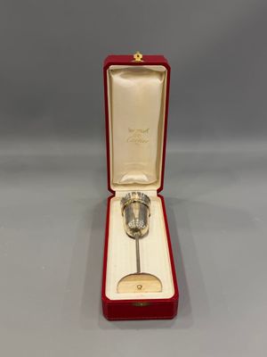 an image of a silver spoon in a red box on a gray surface